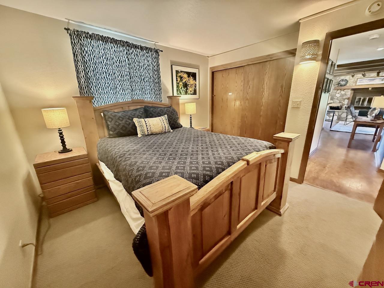 11 Snowmass Road, Unit 337 Crested Butte, CO 81225 - Photo 27 of 35 a bedroom with a bed and wooden floor