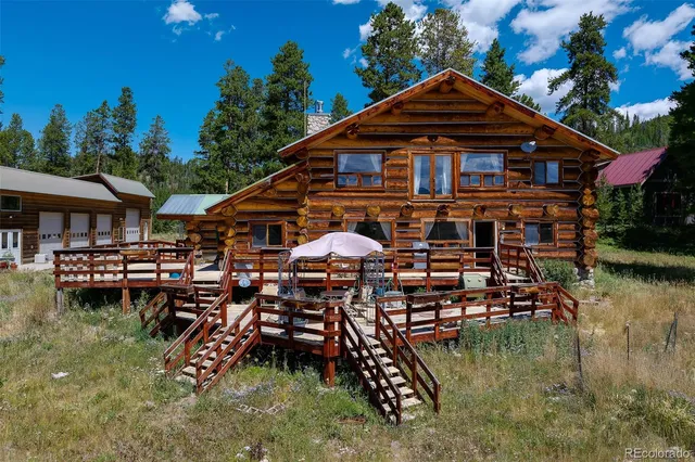 an aerial view of a house with swimming pool and a yard