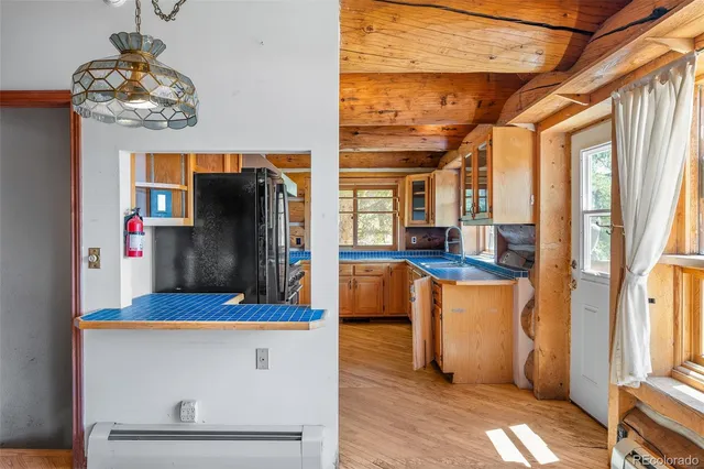 a kitchen with stainless steel appliances granite countertop a sink a stove and wooden cabinets