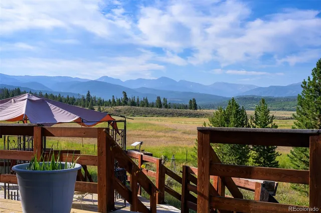 a view of a chairs and table in patio with a lake view
