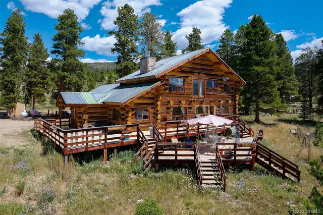 an aerial view of a house with swimming pool table and chairs
