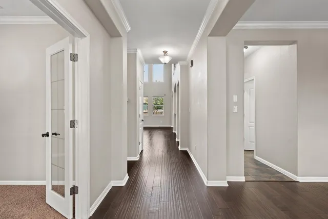 a view of a hallway with wooden floor and closet area
