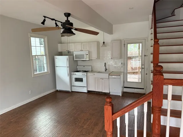 a very nice looking room with wooden floor and windows