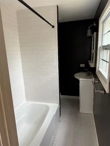 a bathroom with a bathtub and a shower