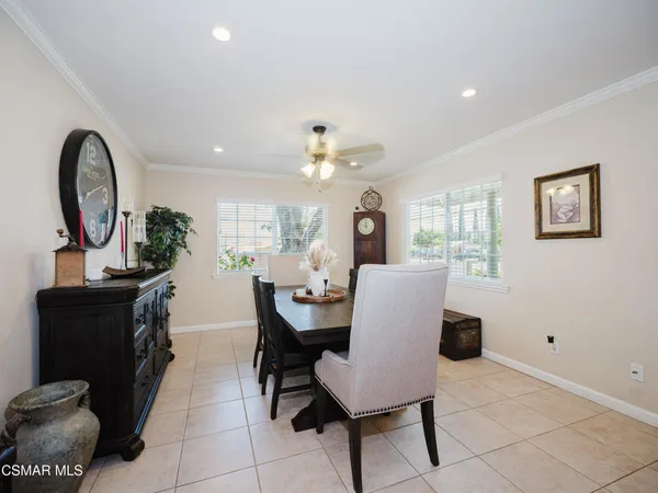 a view of a dining room with furniture and a mirror