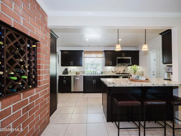 a kitchen with stainless steel appliances a sink and a refrigerator