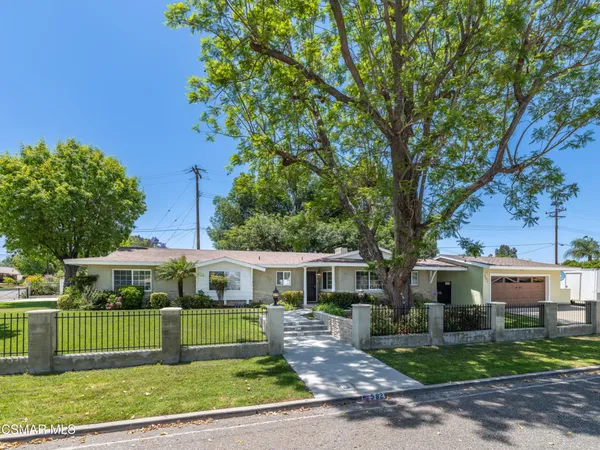 a front view of a house with a yard table and chairs