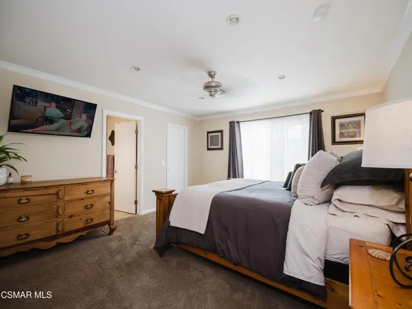 a bedroom with a bed and flat screen tv