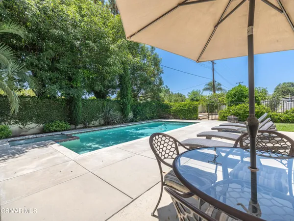 a view of a backyard with sitting area