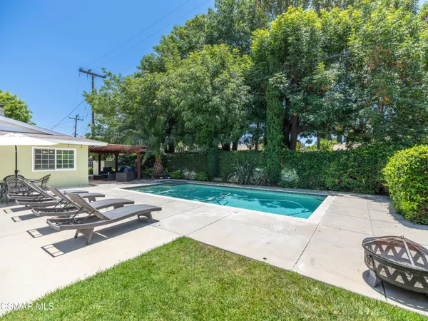 a view of backyard with seating area and green space