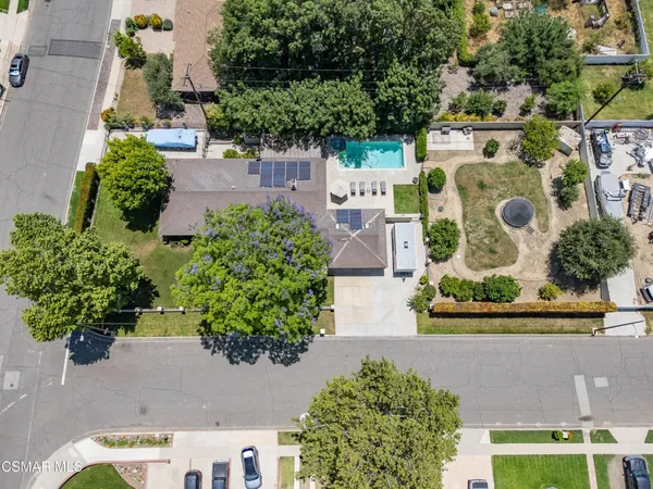 an aerial view of a house with a yard and a fountain