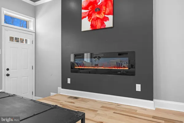 a living room with furniture and view of kitchen