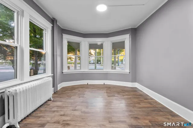 a view of an empty room with large windows