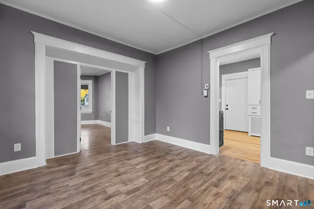a view of hallway with wooden floor