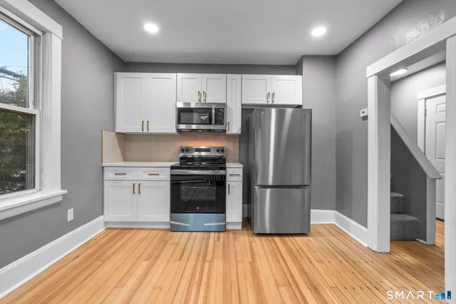 a kitchen with stainless steel appliances a refrigerator and a stove top oven