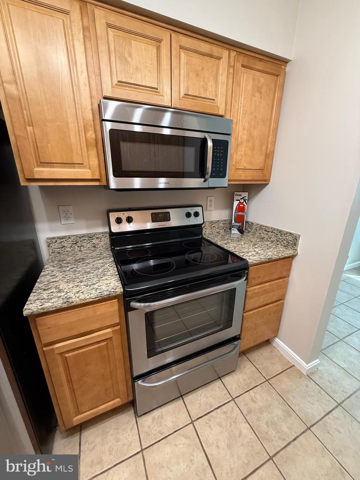 8583 Falls Run Road, Unit B Ellicott City, MD 21043 - Photo 14 of 40 a stove top oven sitting inside of a kitchen