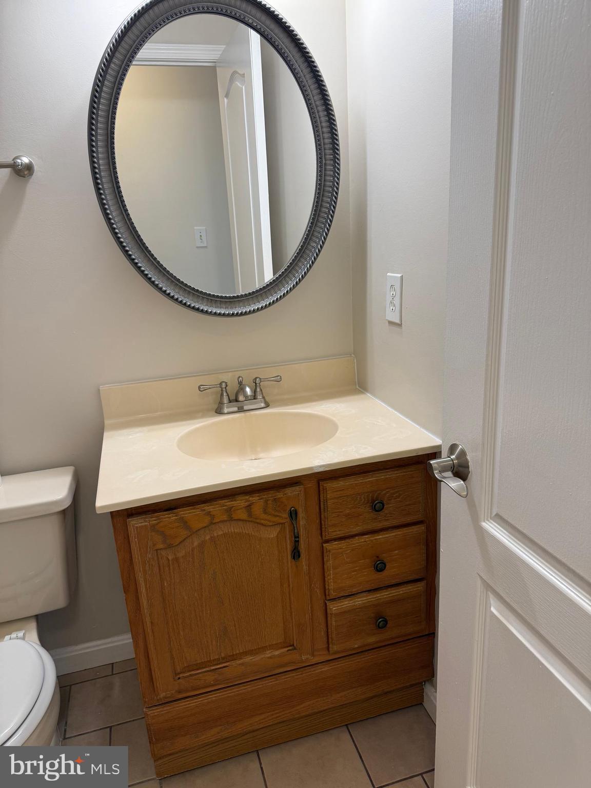 8583 Falls Run Road, Unit B Ellicott City, MD 21043 - Photo 29 of 40 a bathroom with a sink and a mirror