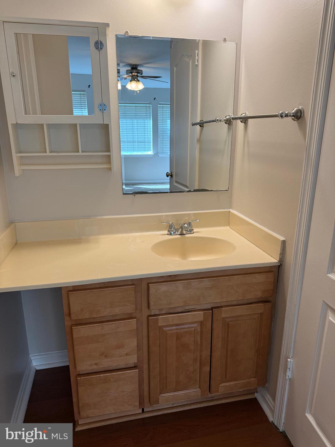 8583 Falls Run Road, Unit B Ellicott City, MD 21043 - Photo 35 of 40 a bathroom with a sink and a mirror