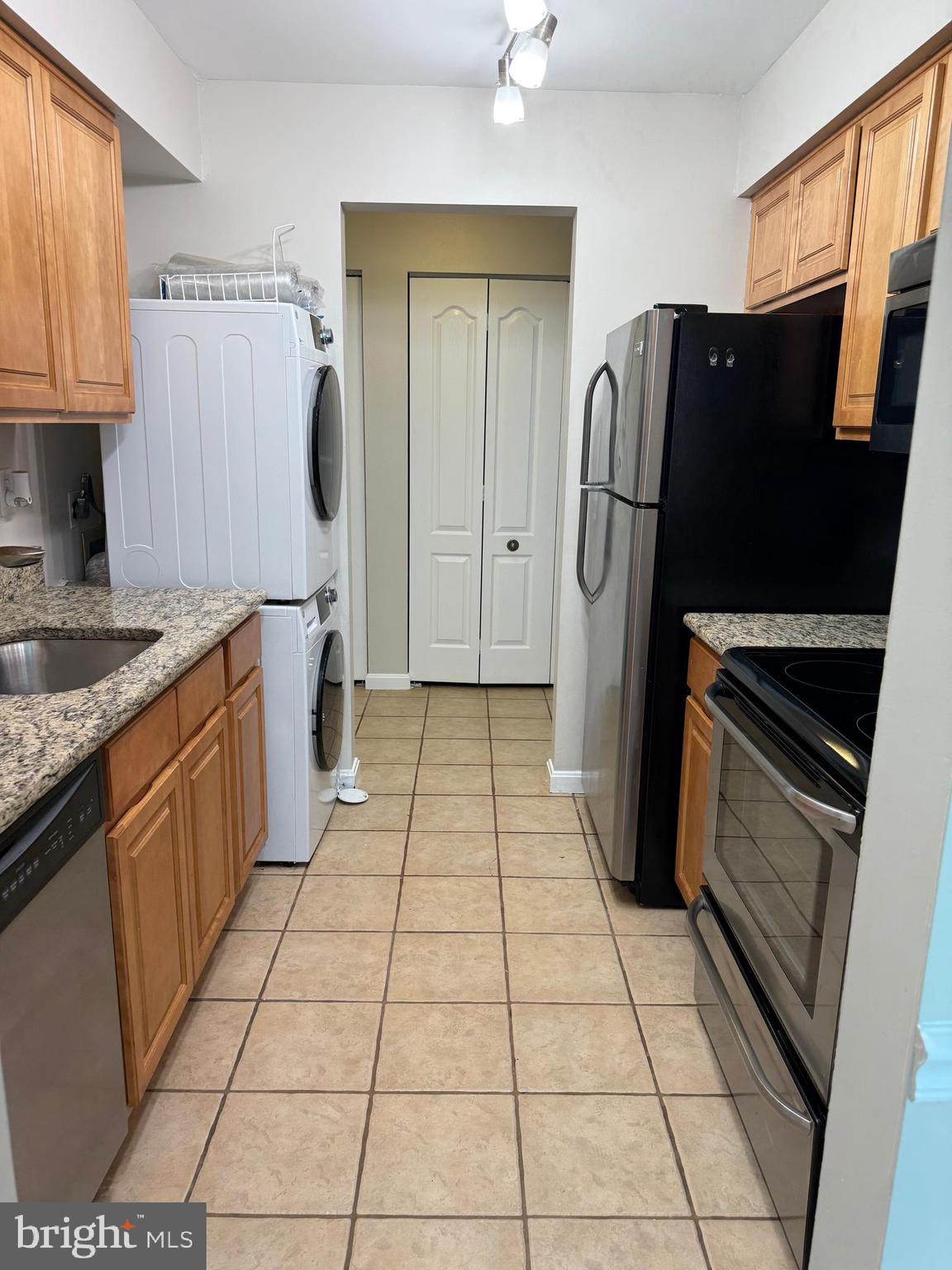 8583 Falls Run Road, Unit B Ellicott City, MD 21043 - Photo 10 of 40 a kitchen with stainless steel appliances granite countertop a refrigerator and a sink