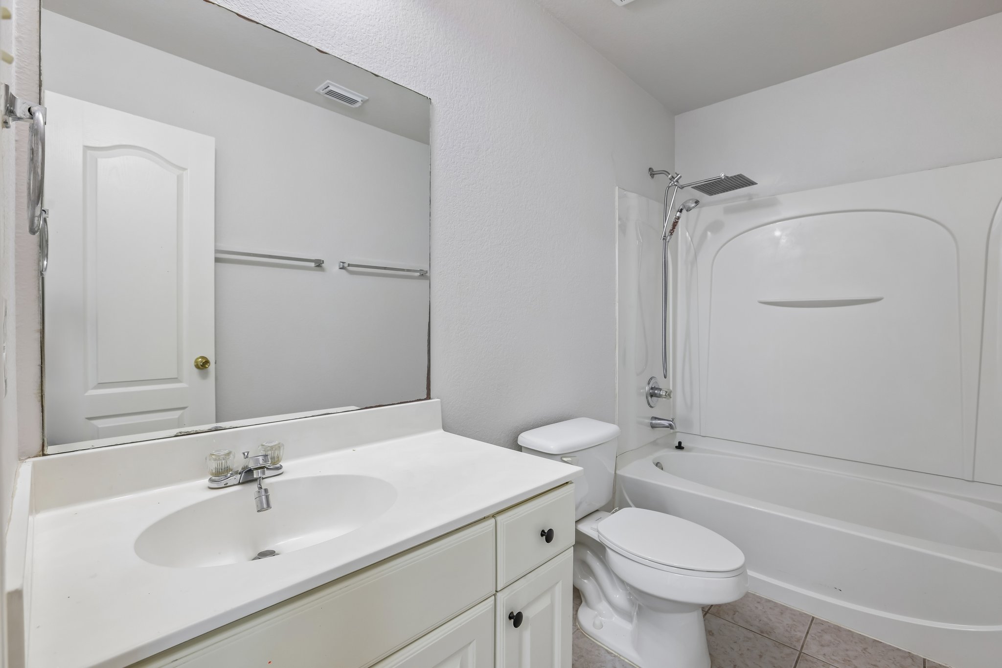 1721 Long Rifle Drive Austin, TX 78754 - Photo 24 of 38 Functional full bathroom with an ample vanity and a combined shower-bathtub unit.