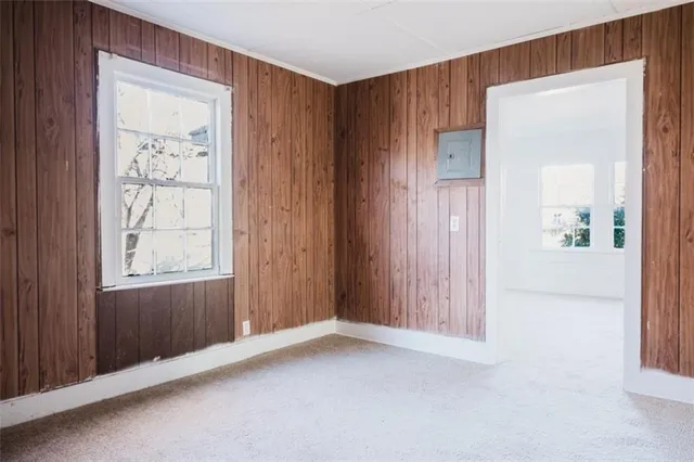 an empty room with windows and closet