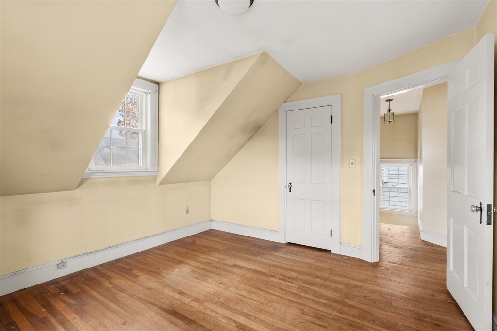 88 Decker Street Milton, MA 02186 - Photo 15 of 20 an empty room with wooden floor and entryway