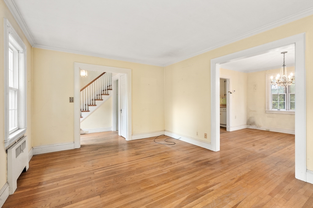 88 Decker Street Milton, MA 02186 - Photo 3 of 20 an empty room with wooden floor and windows