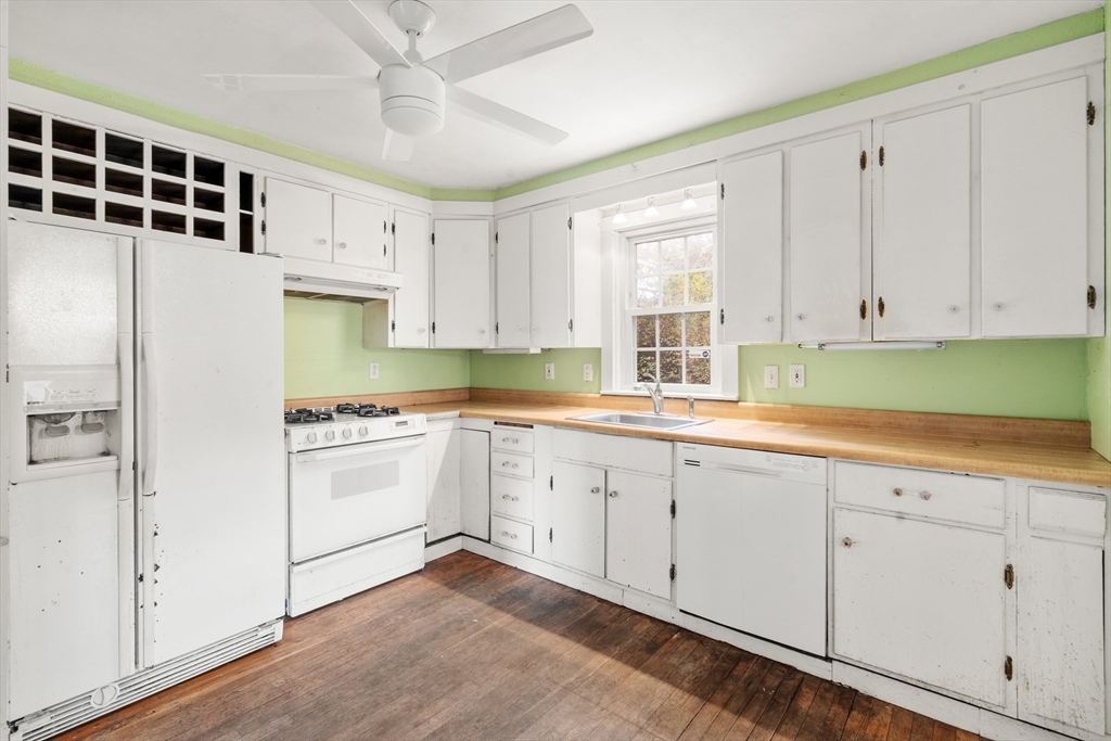 88 Decker Street Milton, MA 02186 - Photo 7 of 20 a kitchen with granite countertop white cabinets and white appliances