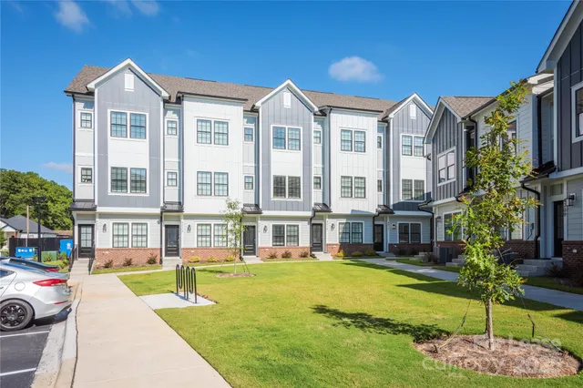 a front view of a residential apartment building with a yard