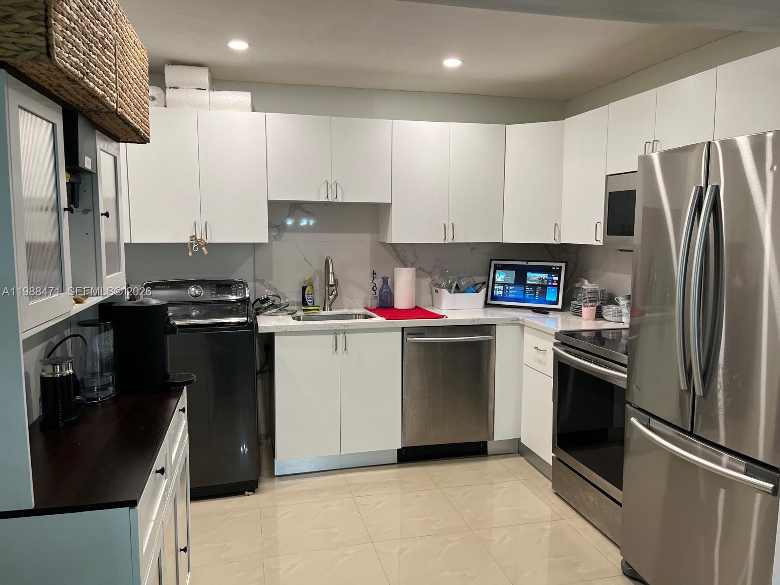 301 North Pine Island Road, Unit 156 Plantation, FL 33324 - Photo 2 of 16 a kitchen with a refrigerator sink and stove