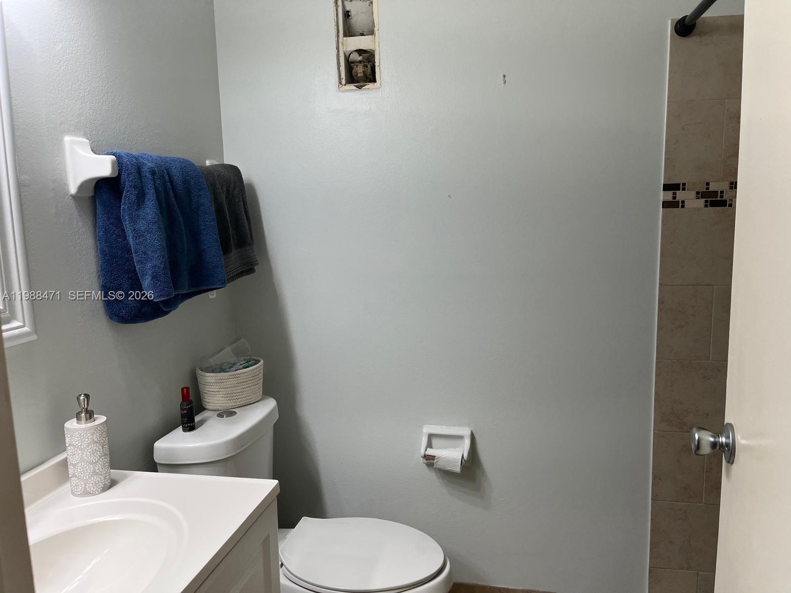 301 North Pine Island Road, Unit 156 Plantation, FL 33324 - Photo 9 of 16 a white toilet sitting next to a bathroom sink