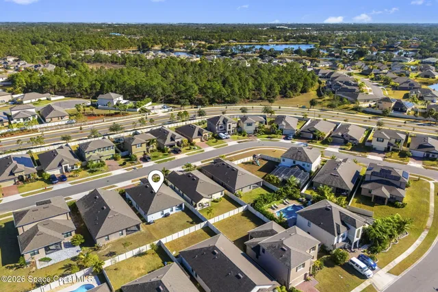 an aerial view of residential houses with outdoor space