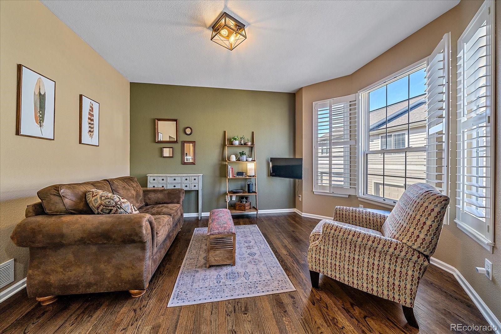 6318 Trailhead Road Highlands Ranch, CO 80130 - Photo 10 of 32 a living room with furniture and a large window