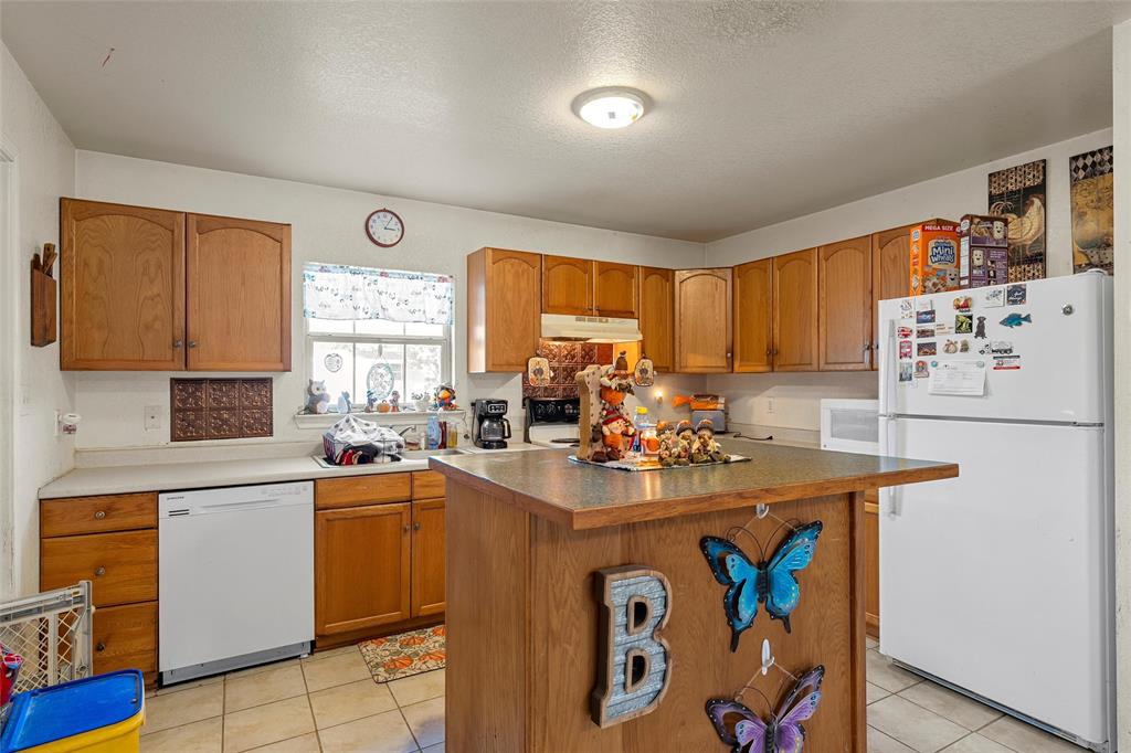 5288 Ft Graham Road West, TX 76691 - Photo 9 of 19 a kitchen with a sink a stove and cabinets