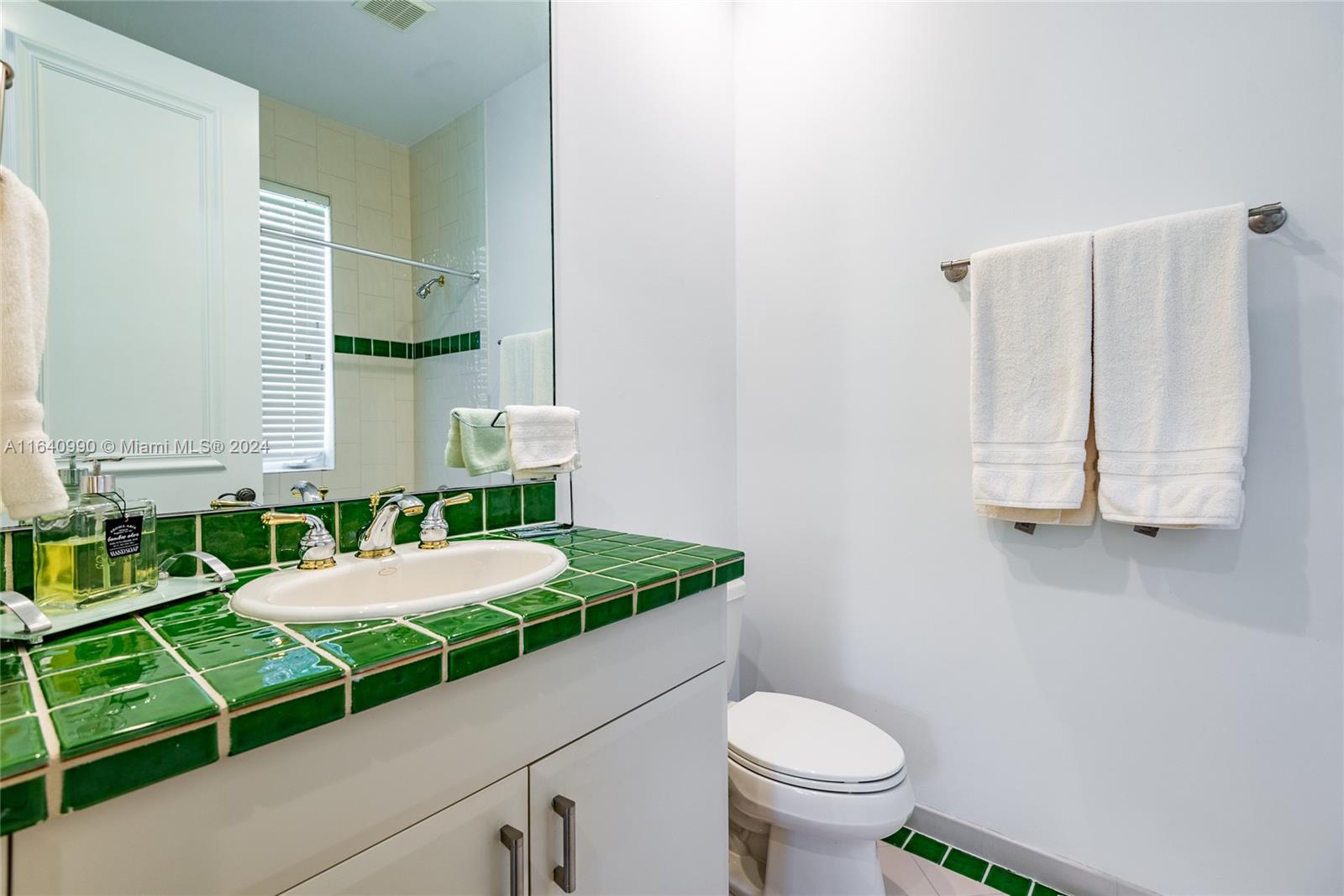 17586 Middlebrook Way Boca Raton, FL 33496 - Photo 43 of 86 a bathroom with a granite countertop toilet a sink and a mirror