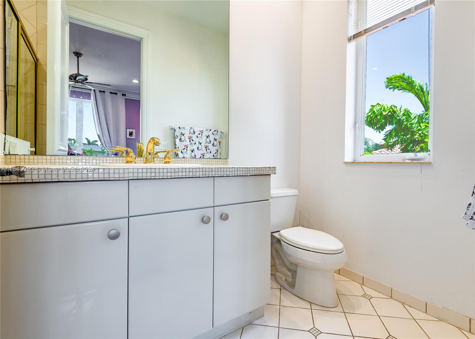 17586 Middlebrook Way Boca Raton, FL 33496 - Photo 50 of 86 a bathroom with a granite countertop sink a toilet and a mirror