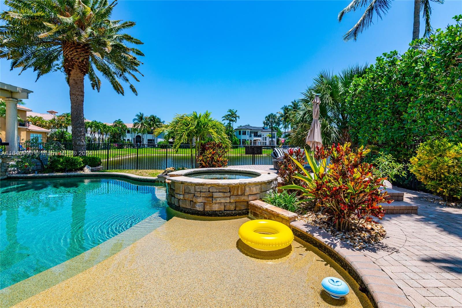 17586 Middlebrook Way Boca Raton, FL 33496 - Photo 57 of 86 a view of a swimming pool with a patio and a garden
