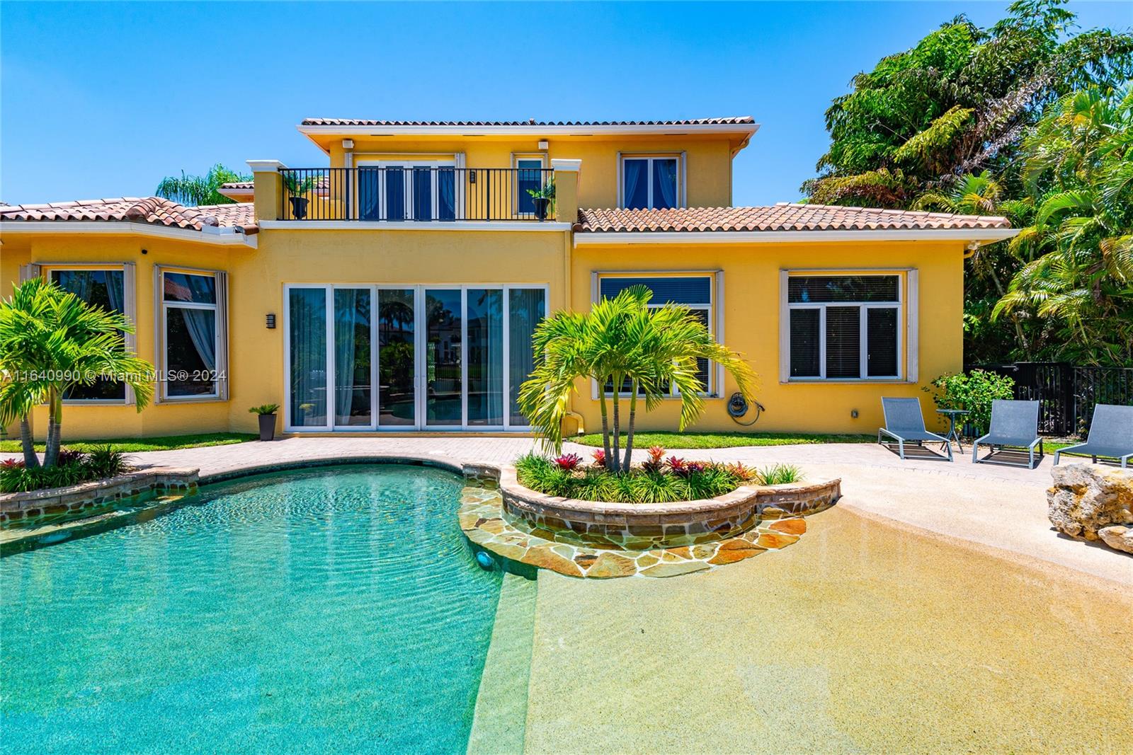 17586 Middlebrook Way Boca Raton, FL 33496 - Photo 61 of 86 a front view of a house with a yard table and chairs
