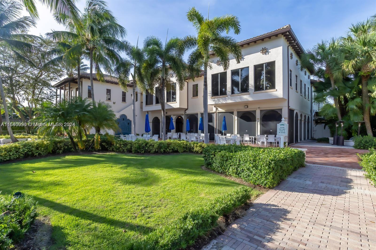 17586 Middlebrook Way Boca Raton, FL 33496 - Photo 78 of 86 a front view of a residential apartment building with a yard and potted plants