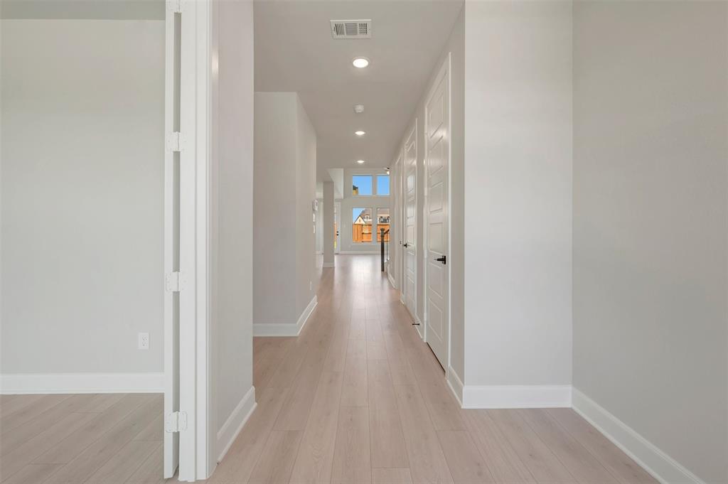4308 Palomino Road Aubrey, TX 76227 - Photo 8 of 40 a view of a hallway with wooden floor