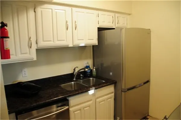 a kitchen with a sink and cabinets