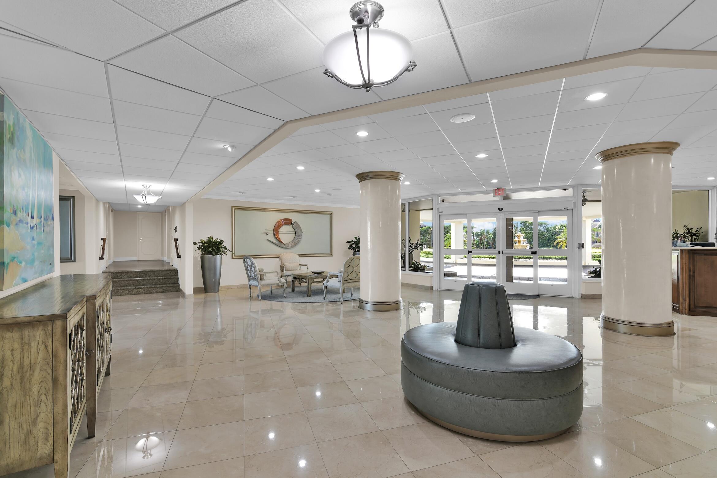 600 South Ocean Boulevard, Unit 802 Boca Raton, FL 33432 - Photo 16 of 27 a living room with fireplace furniture and a view of kitchen