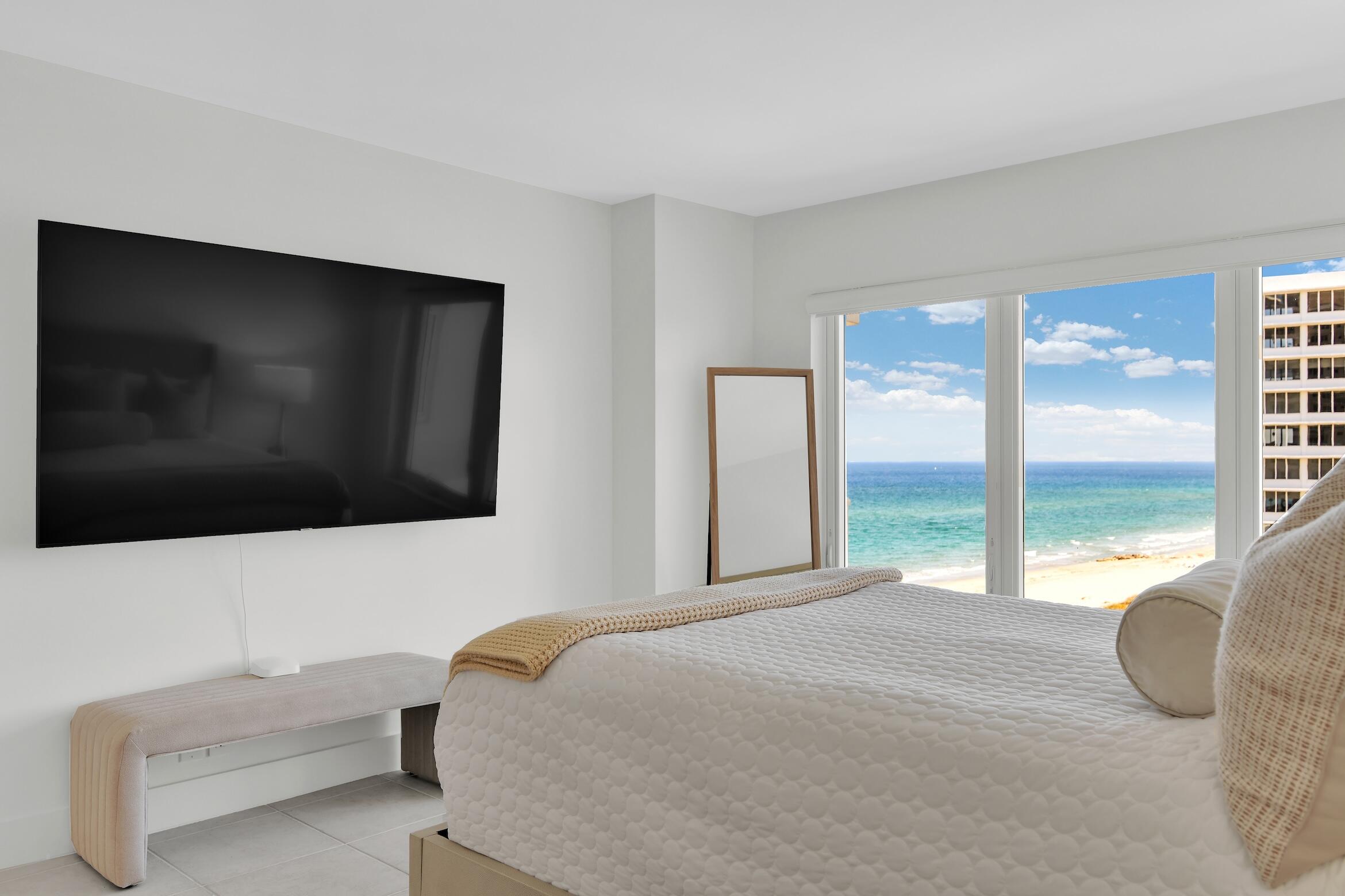 600 South Ocean Boulevard, Unit 802 Boca Raton, FL 33432 - Photo 5 of 27 a bedroom with a bed and glass window