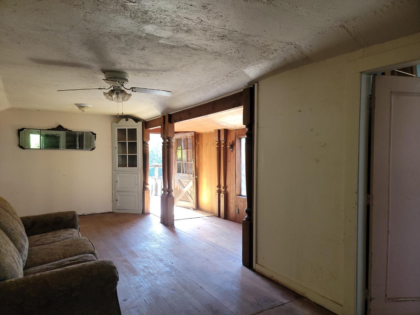 159 Strawberry Road Watsonville, CA 95076 - Photo 49 of 109 a view of a livingroom with wooden floor and a ceiling fan