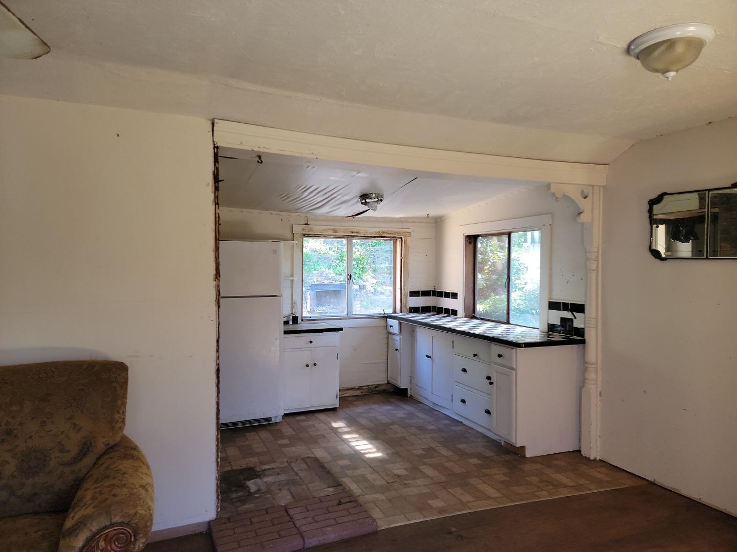 159 Strawberry Road Watsonville, CA 95076 - Photo 86 of 109 a kitchen with granite countertop cabinets a sink a window and stainless steel appliances