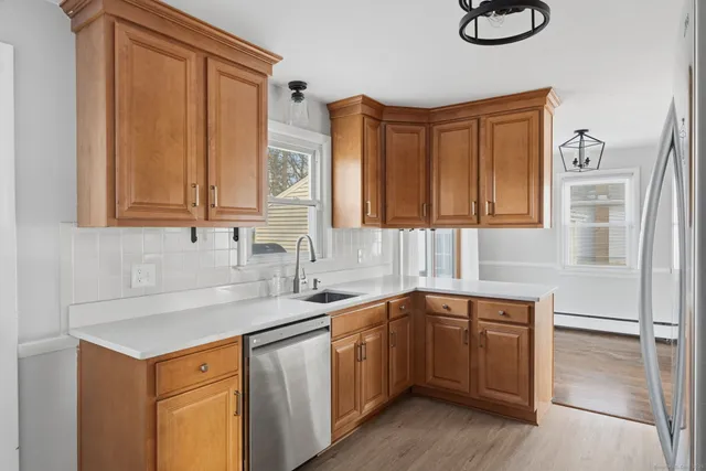 a kitchen with stainless steel appliances granite countertop a sink and dishwasher cabinets with wooden floor