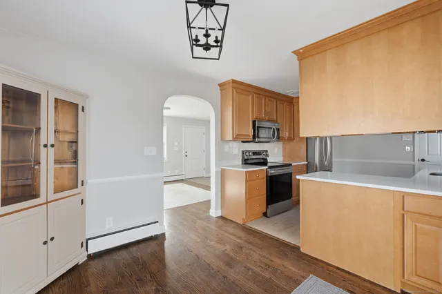 a kitchen with a refrigerator and a stove top oven