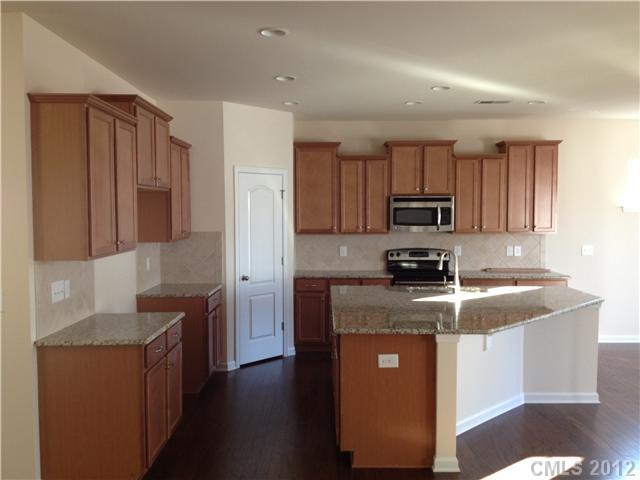 4017 Perth Road, Unit 400 Indian Land, SC 29707 - Photo 3 of 11 a kitchen with stainless steel appliances granite countertop a sink stove and refrigerator