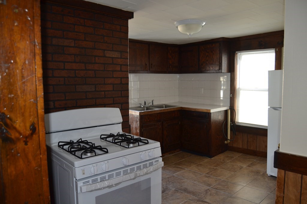8 Cedar Court Lowell, MA 01852 - Photo 11 of 28 a kitchen with a stove and a refrigerator
