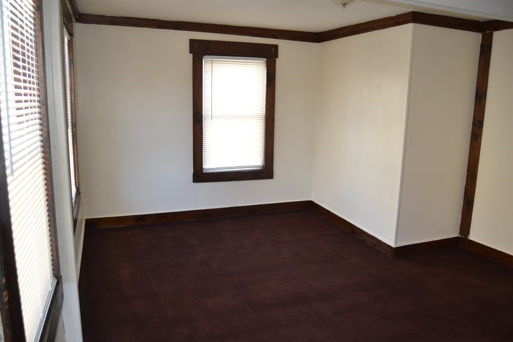 8 Cedar Court Lowell, MA 01852 - Photo 13 of 28 a view of an empty room with wooden floor and a window